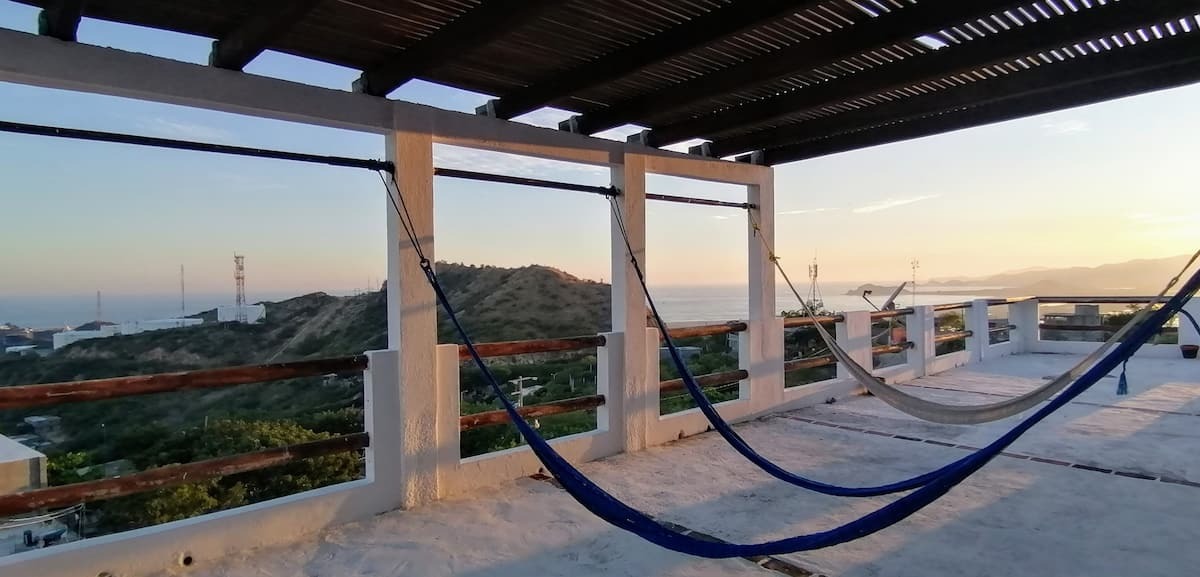 Terrace with hammocks and port views at Casa Mirador Hotel & Surf Camp